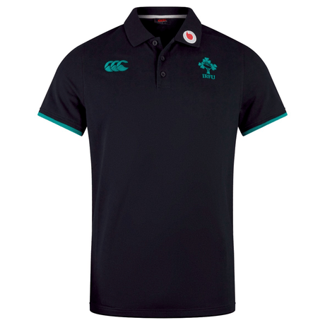 The Ireland 25/26 Team Polo by Canterbury is a black short-sleeve cotton polo with teal accents, embroidered IRFU and Canterbury chest logos, and a Vodafone logo on the right collar.