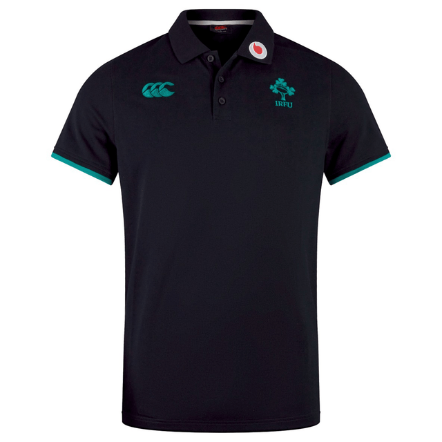The Ireland 24 Team Polo by Canterbury is a black cotton polo with green accents, featuring a ribbed collar and cuffs, classic clover emblem, "IRFU" text, and embroidered chest logos.