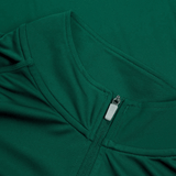 Close-up of a green Ireland 24 Vapodri First Layer by Canterbury, highlighting its zippered neckline with a pull tab. The smooth, fitted fabric showcases Canterbury's advanced VapoDri technology.