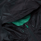 Detailed look at the Ireland 24 Wind Resistant Jacket by Canterbury, showcasing a black hooded design, green mesh lining, and partially closed zipper with Vaposhield technology.
