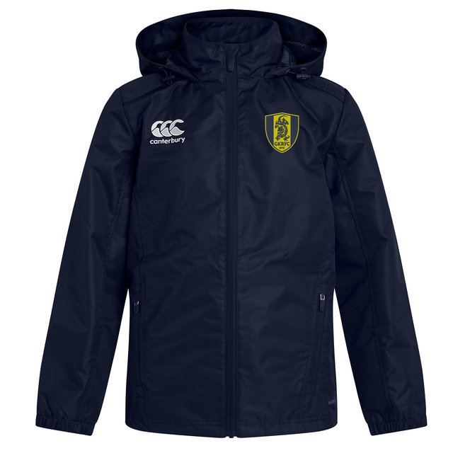 The Gotham Knights Club Vaposhield Stadium Jacket by EMB Canterbury is a navy blue sports jacket with a hood, featuring the Canterbury logo on the right chest and a yellow and green crest on the left. This water-repellent jacket is perfect for all-weather conditions.