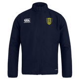 The Gotham Knights Club Track Jacket by EMB Canterbury is a lightweight navy blue jacket featuring the Canterbury logo on the right chest and a yellow and blue shield emblem on the left chest. It is water repellent to keep you dry in various conditions.
