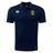 A navy blue Gotham Knights Club Dry Polo shirt by EMB Canterbury, featuring short sleeves, a yellow and black shield emblem on the left chest, and white logos on the right chest and sleeve. The shirt integrates Vapodri Technology to ensure breathability for ultimate comfort.
