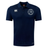 The Saint Anselm College Club Rugby Club Dry Polo by EMB Canterbury is a navy blue short-sleeve polo with Vapodri Technology, a white embroidered logo on the left chest, and two white brand logos on the chest and right sleeve.