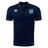 The Minneapolis Mayhem Rugby Club Dry Polo by Canterbury, from EMB Canterbury, is a navy blue short-sleeve polo featuring Vapodri Technology for enhanced comfort. It displays two white logos on the chest and a distinctive blue-and-white Minneapolis Mayhem badge on the left side, making it an ideal breathable option for active wear.