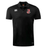 The Rye High School 10 Year Club Dry Polo by Canterbury from EMB Canterbury is a black sports shirt with a collar, featuring embroidered logos on the chest and a "VapoDri" label at the hem. This polo incorporates VapoDri Technology to ensure it remains breathable and comfortable during your activities.