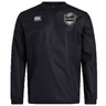 Black long-sleeved ICRON Club Vaposhield Contact Top by Canterbury featuring a brand logo on the right chest and a shield emblem with a rugby ball on the left.