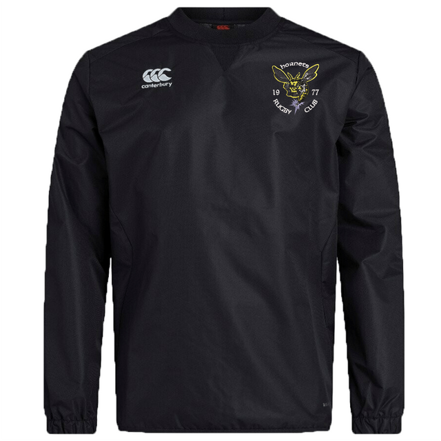 A black long-sleeve Hornets Rugby Club 1977 Club Vaposhield Contact Top by EMB Canterbury, featuring the Canterbury logo on the right chest and a Hornets Rugby Club emblem on the left chest. This custom rugby top is equipped with Vaposhield technology, providing durable comfort and protection for every training session.