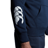 A man wearing a Canterbury Club Hoodie with Canterbury sleeve branding.