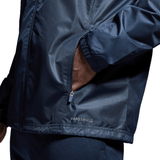 A person wearing a Canterbury Club Vaposhield Full Zip Rain Jacket with water-resistant VapoShield technology has one hand in the zippered pocket. Only the lower half of the jacket and part of the arm are visible.