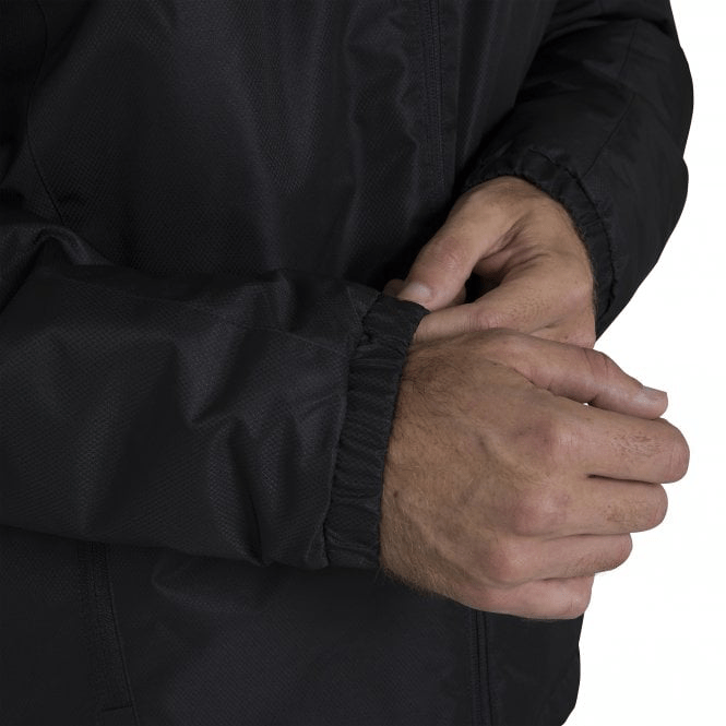 A man wearing a Canterbury Club Vaposhield Stadium Jacket with a hood.