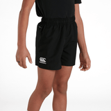 A young boy in a Canterbury Club Short and black shirt.