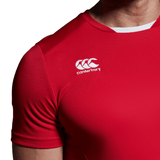 A man wearing a red Canterbury Club Dry Tee with a white logo.