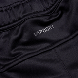 Close-up of the black athletic fabric labeled "Canterbury," showcasing an elastic waistband and smooth, breathable texture. Perfect for the Irish rugby fan, these Ireland 24 Poly Knit Pants by Canterbury incorporate VapoDri technology, ensuring comfort during intense matches.