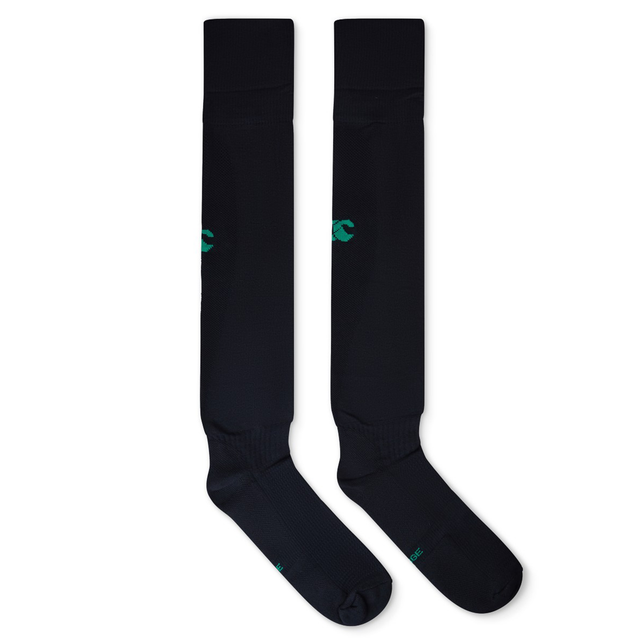 The Ireland 25/26 Alternate Socks by Canterbury are long black socks laid flat side by side, each with a small green logo and made from fast-drying yarn for comfort.