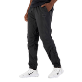 A person wearing black Canterbury Tempo Vaposhield Dome Pant and white sneakers, standing sideways with focus on the clothing.
