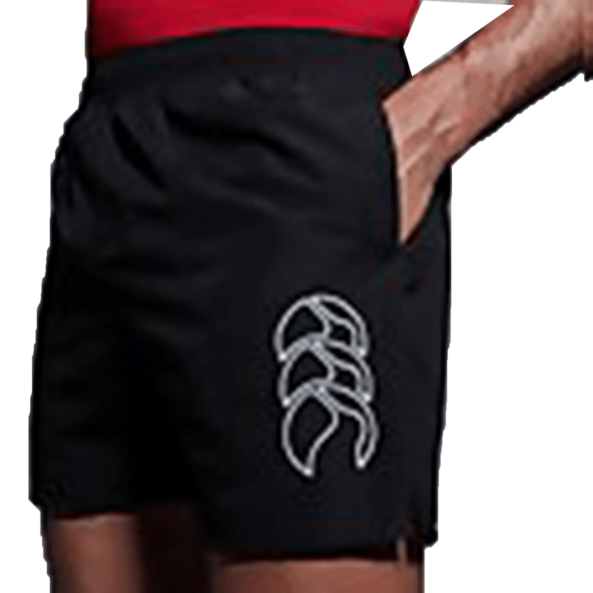 A man wearing a Canterbury red shirt and Canterbury black Tactic shorts.