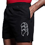 A man wearing a Canterbury red shirt and Canterbury black Tactic shorts.