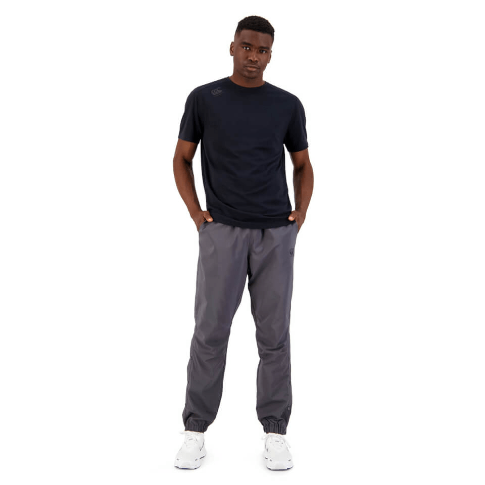 A man wearing a Canterbury Tempo Vapodri T-shirt and grey jogging pants.