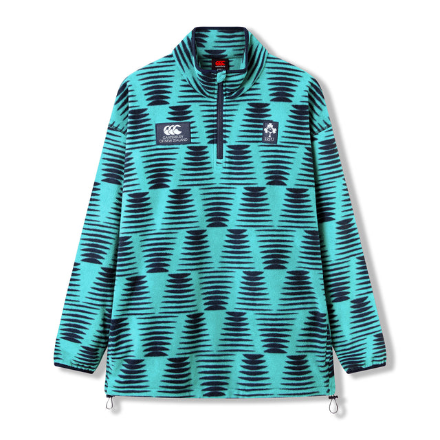 The Ireland 26 Retro Fleece 1/4 Zip by Canterbury is a long-sleeve pullover featuring a teal and navy geometric pattern, a zip collar, and embroidered chest logos. Designed in the classic Canterbury 1/4 Zip style, this rugby fleece is shown on a plain white background.