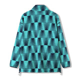 A turquoise Canterbury Ireland 26 Retro Fleece 1/4 Zip jacket, featuring a navy blue wave-like geometric pattern and adjustable drawstrings at the hem, shown from the back—reminiscent of classic rugby fleeces.