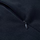 Close-up of a black zipper partially closed on dark fabric, highlighting the zipper pull and material texture on the Ireland 26 Hybrid Padded Jacket by Canterbury.