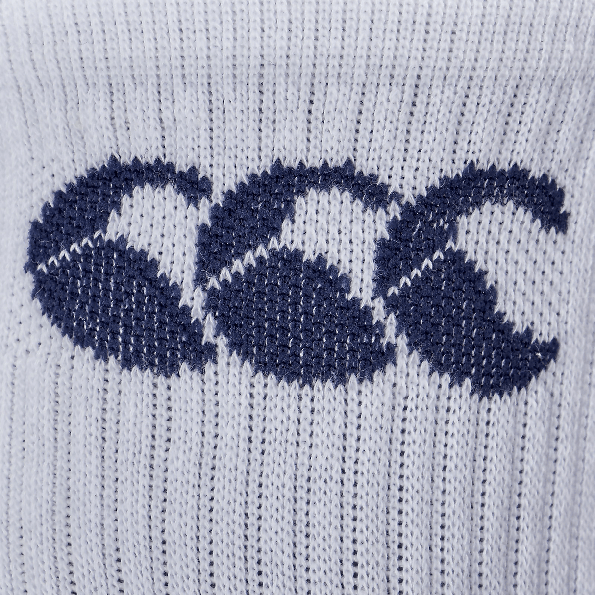 Close-up of a white cotton-rich Canterbury 3 Pack Crew Sock knitted fabric with three blue crescent-shaped designs.