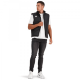 A man wearing a Canterbury Core Gilet vest and white shirt.