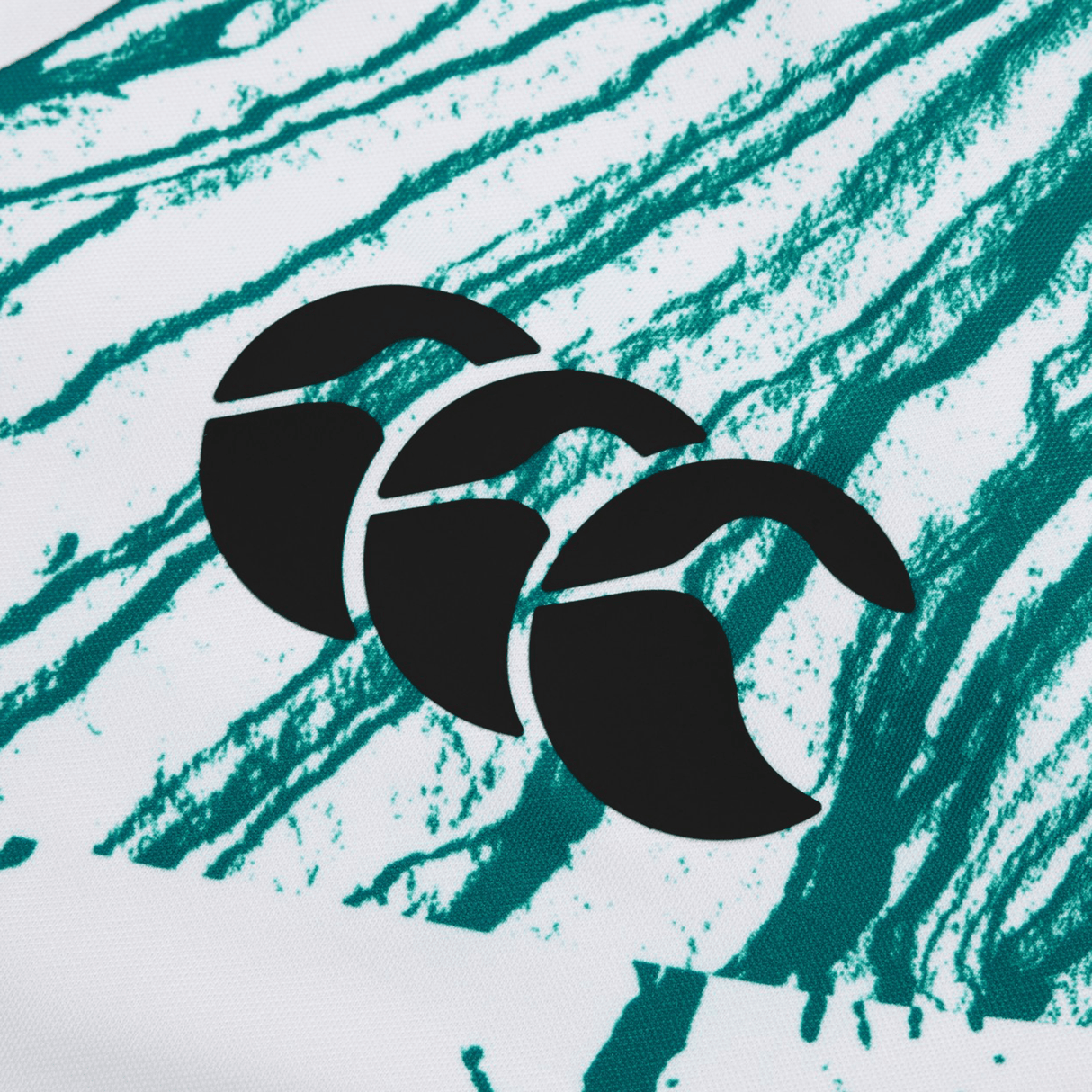 A black logo with three crescent shapes on a white background with green streaks, reminiscent of the Ireland 24 Alternate Test Jersey by Canterbury.