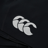 Close-up of a black fabric Ireland 24 Training Short by Canterbury, featuring a white embroidered logo with three overlapping stylized tongues.