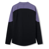 The Ireland 26 Tech Drill Top by Canterbury features a black body with distinctive purple shoulder and upper sleeve panels, displayed from the back against a white background. Designed in the style of an Ireland rugby drill top, this performance-driven piece brings authentic Canterbury IRFU training wear to your everyday wardrobe.