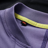 Close-up of the collar on the Ireland 26 Tech Drill Top by Canterbury, highlighting the purple fabric with yellow inner trim and a black tag featuring a red logo—premium details that exemplify official Canterbury IRFU training wear.