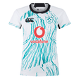 The Women's Ireland 24 Alternate Pro Jersey by Canterbury features an abstract green pattern on a white and teal rugby jersey. It prominently displays the Vodafone, IRFU logos, and the IRFU Crest, combining style and tradition for fans.