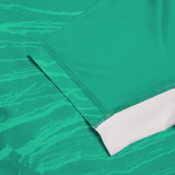 Close-up of textured wave-like patterns on the Women's Ireland 24 Home Pro Jersey by Canterbury, showcasing a green fabric with a white hem.