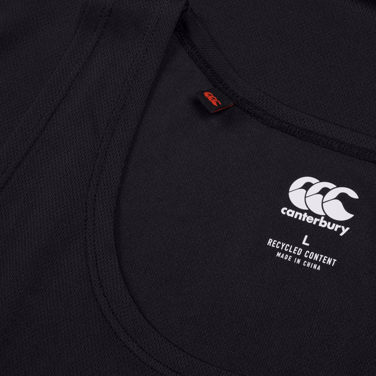 A black Ireland 24 Poly Training Singlet by Canterbury is shown close-up, featuring the logo and size "L." "Recycled Content, Made in China" emphasizes its eco-friendliness. The quick-drying fabric enhances performance.
