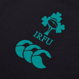A close-up of the IRFU logo, highlighting a shamrock and rugby ball, appears on the Ireland 24 Poly Training Singlet by Canterbury. Below it is Canterbury's emblem on quick-dry fabric.
