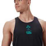 The individual wears the Ireland 24 Poly Training Singlet by Canterbury, a black sleeveless shirt featuring the IRFU logo with a shamrock and green text. Made from quick-drying fabric, it combines performance and style seamlessly.