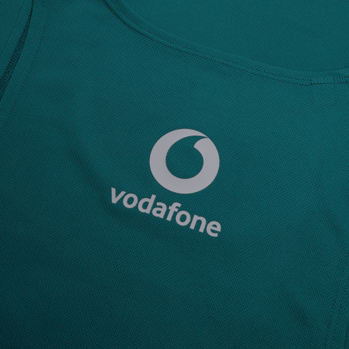 The Canterbury Ireland 24 Poly Training Singlet features quick-drying green fabric with a white Vodafone logo and circular design above it.