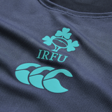 Close-up of the Ireland 26/27 Summer Tour Superlight Training Singlet by Canterbury, in dark blue, featuring the IRFU clover and Canterbury logos in teal—a lightweight design ideal for training.