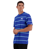 A man wearing a blue, short-sleeve Canterbury Yarn Dye T-Shirt, made from 100% cotton and featuring a small Canterbury logo on the chest, stands facing slightly to the left against a white background.