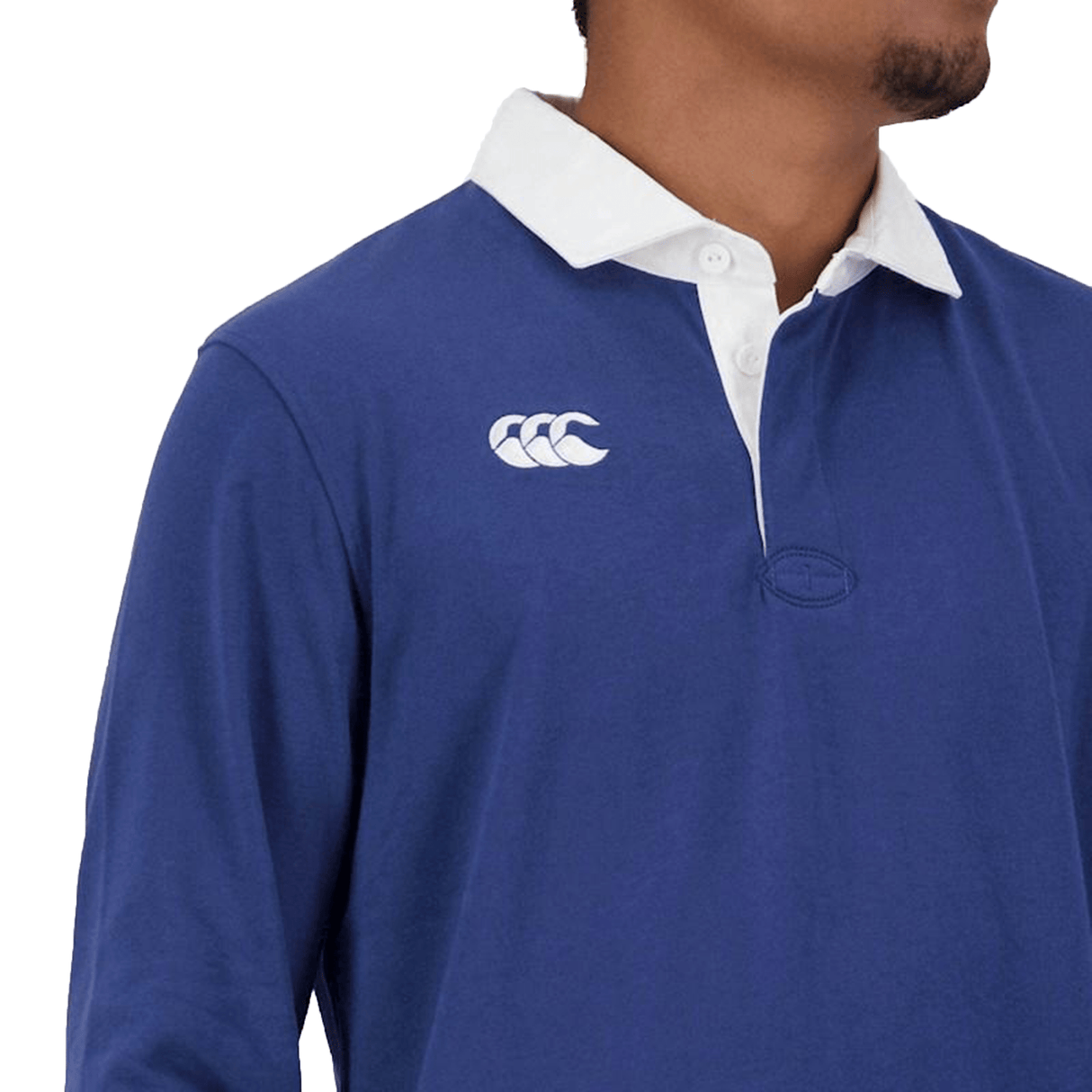 Man wearing a Canterbury Fundamentals Solid Long Sleeve Rugby Jersey with a white collar and a logo on the chest.