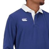Man wearing a Canterbury Fundamentals Solid Long Sleeve Rugby Jersey with a white collar and a logo on the chest.