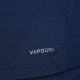 Close-up of navy blue Canterbury Large Logo Superlight Tee AM fabric with "VAPODRI" in white, showing stitching and texture details on this lightweight Canterbury performance shirt.