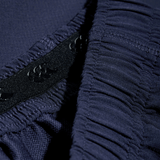 A close up of the Canterbury Yokohama Short button on a blue shirt by Canterbury.