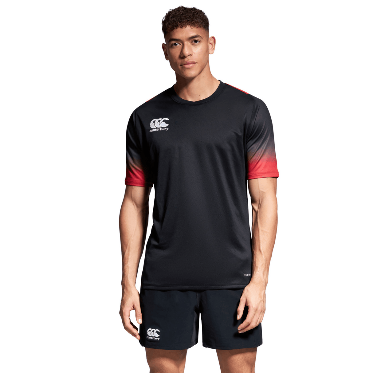 A man wearing a black and red Canterbury Yokohama Short and shirt.