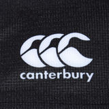 Close-up of the Bundle Canterbury logo on a textured black fabric background, showcasing the durable fabric of the Women's Canterbury Yokohama Short 3-Pack Bundle.