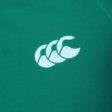A close-up of the Ireland 25/26 Long Sleeve Classic Home Jersey by Canterbury shows a green fabric with a white logo featuring three overlapping curved shapes, capturing the iconic design.