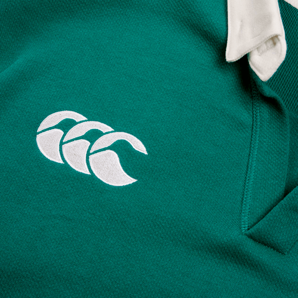 The Ireland 24 Home Classic Jersey by Canterbury is a vibrant green garment featuring the iconic white Canterbury logo with three overlapping curves, reflecting the Irish spirit.