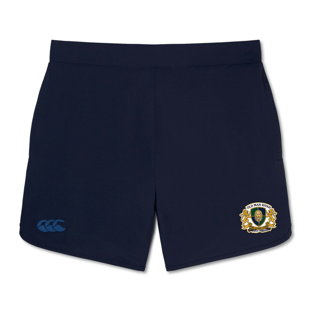 The Old Man Rivah Rugby Women's Elite Woven Short by EMB Canterbury features a navy blue design with a lion crest on the right leg, a blue Canterbury logo on the left leg, and zippered pockets for secure storage during training.