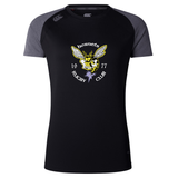 The Hornets Rugby Club 1977 Women's Elite Training Tee by WRS Canterbury is a black and gray short-sleeve shirt featuring a hornet logo, “Hornets Rugby Club” text, and “1977” on the front. Inspired by elite training designs, it offers lightweight comfort and moisture-wicking fabric for performance both on and off the field.
